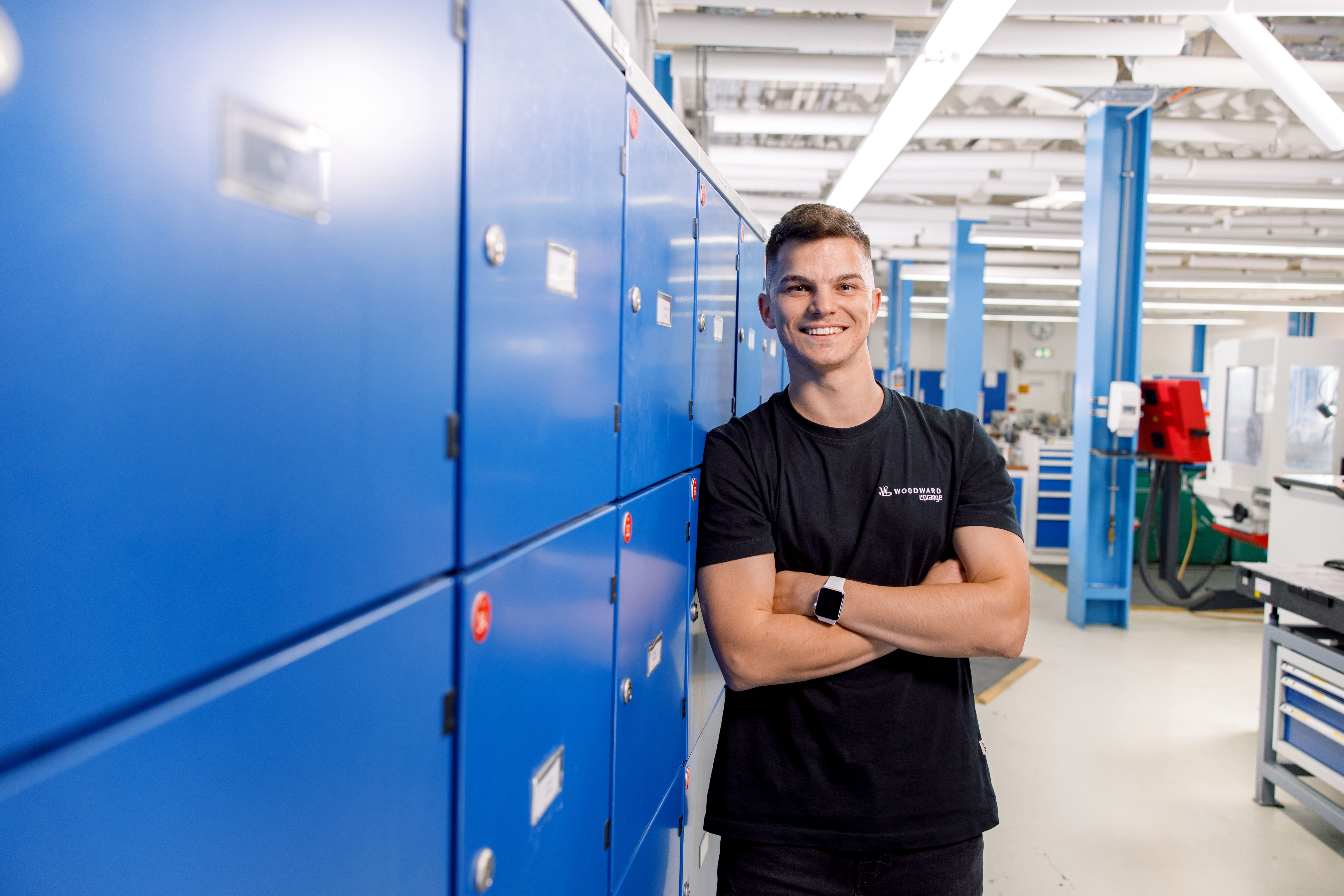 smiling employee with arms crossed